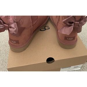 Ugg Mini Bailey Bow Glimmer Boot, in pink size 10. Never worn,in original box.